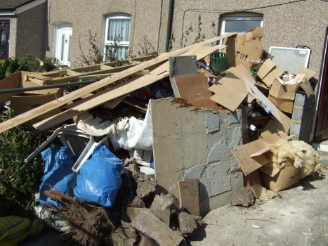 Team working on garage clearance steps in North West London